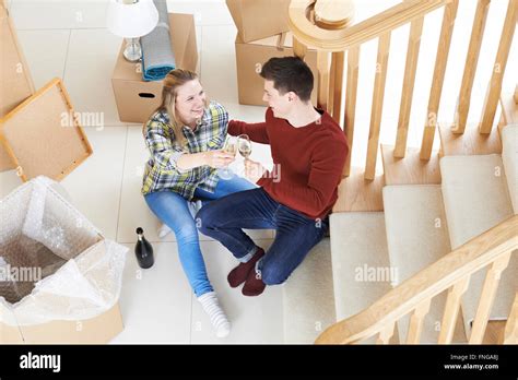 Couple Celebrating Moving Into New Home With Champagne Stock Photo Alamy