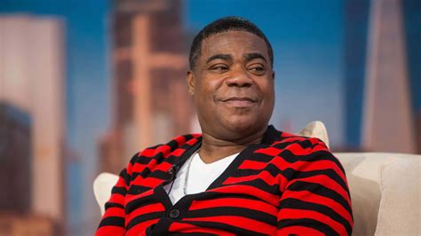 Download Tracy Morgan Smiling On Stage In Front Of Camera Wallpaper