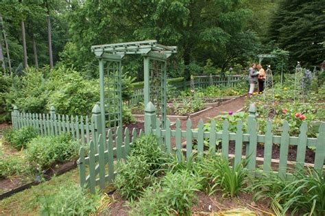 Vegetable Garden With A Green Picket Fence Traditional Landscape