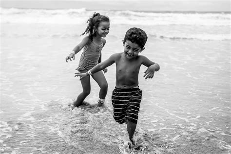 Grayscale Photo Of 2 Girls Running On Beach · Free Stock Photo