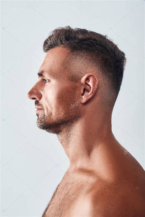 Confident And Handsome Side View Of Charming Man With A Stubble Standing Agains Spon Sid