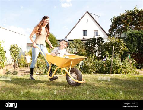 Woman Pushing A Wheelbarrow High Resolution Stock Photography And