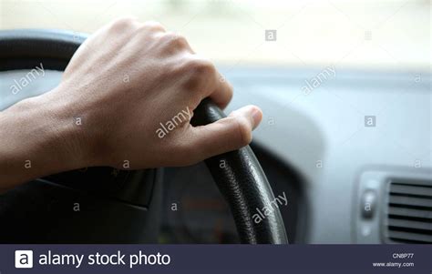 Close Up Of A Male Hand On Steering Wheel In A Modern Car In The Uk