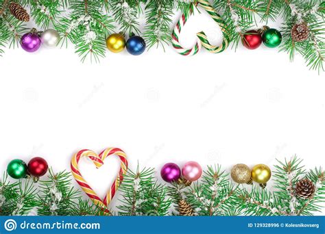 Christmas Frame Of Fir Tree Branch With Candy Canes And Balls Isolated