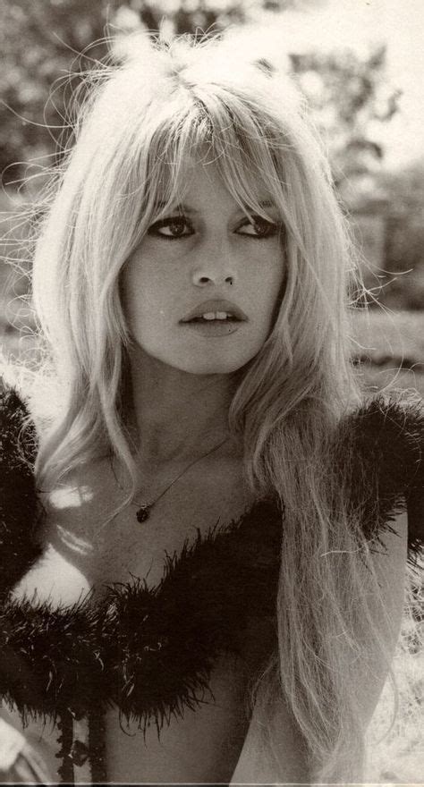 A Black And White Photo Of A Woman With Long Blonde Hair Wearing A Fur Coat
