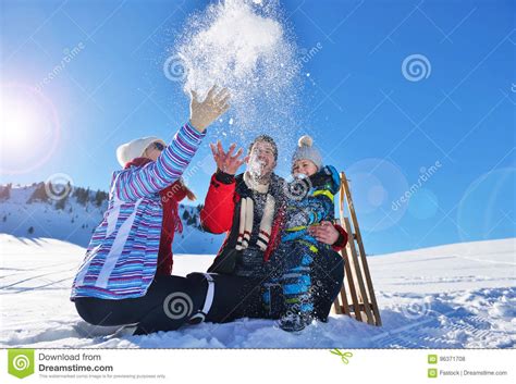 Manufactured from malaysian dark red meranti wood treated with teak oil, tioman outdoor hardwood folding coffee table is sturdy and stable to hold snacks and drinks while enjoying a beautiful sunny day. Happy Young Family Playing In Fresh Snow At Beautiful Sunny Winter Day Outdoor In Nature Stock ...
