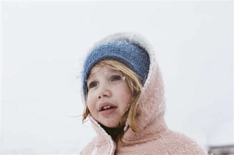 Portrait Of Little Girl In Snowfall Stock Photo