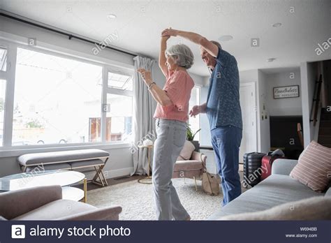 Senior Couple Dancing In Living Room Stock Photo Alamy