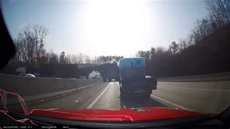 cover flies off a truck onto the road as another runs it over youtube