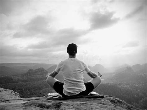 Alone Sitting Man Practicing Yoga Pose On The Rocky Peak Man Within