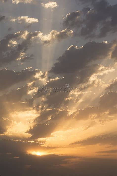 Sunrise With Dramatic Dark Clouds And Light Rays Through Clouds At Sky