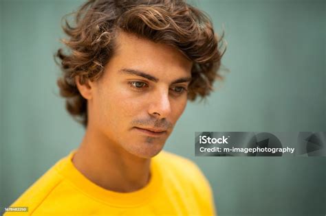 Handsome Young Man Looking Down And Thinking Stock Photo Download