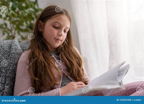 Child Reading A Book At Home By The Window Stock Photo Image Of
