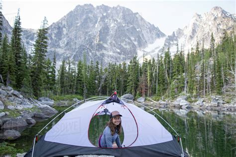Young Woman Sitting In Tent Beside Lake The Enchantments Alpine Lakes