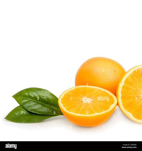 Orange Whole And Cut Into Halves With Leaves Isolated On A White