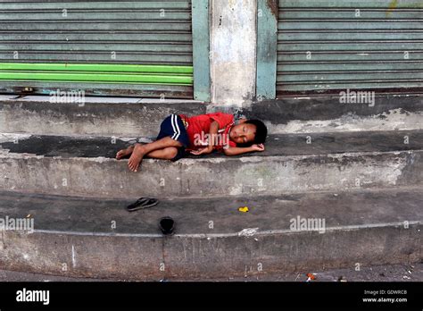 Homeless Child Sleeping On Street High Resolution Stock Photography And