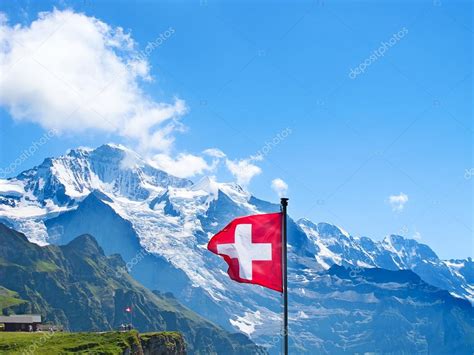 The flag of switzerland (german: Флаг Швейцарии на вершине Манлишайна — Стоковое фото ...