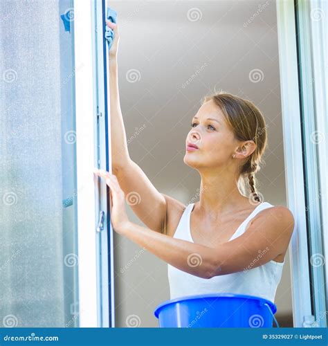 Pretty Young Woman Doing House Work Washing Windows Stock Image
