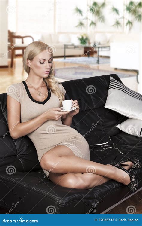 Sitting On Sofa Drinking From A Cup Stock Image Image 22085733