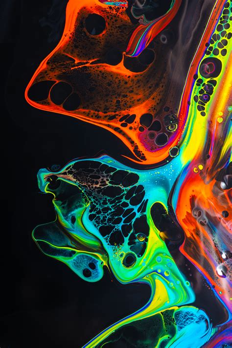 Colorful Mix Of Neon Paints Swirling On Black Surface · Free Stock Photo