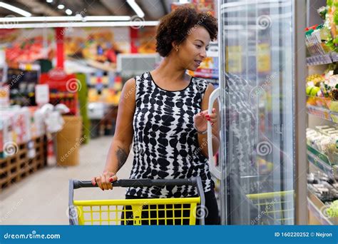 Pretty Black Woman Choosing Goods In A Grocery Store Stock Photo