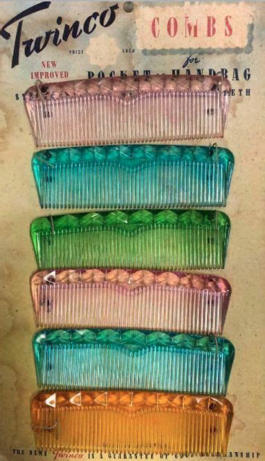 Four Different Colored Combs Sitting On Top Of Each Other In Front Of A