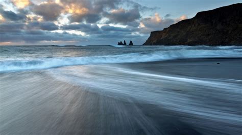 Sea Stacks Of Reynisdrangar At Sunrise From The Black Volcanic Sand