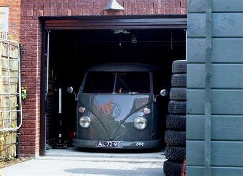 An Old Vw Bus Is Parked In The Garage