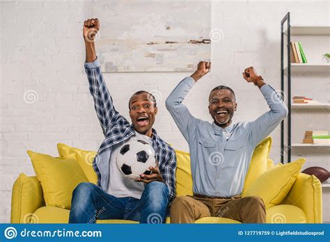 Cheerful African American Father With Adult Son Holding
