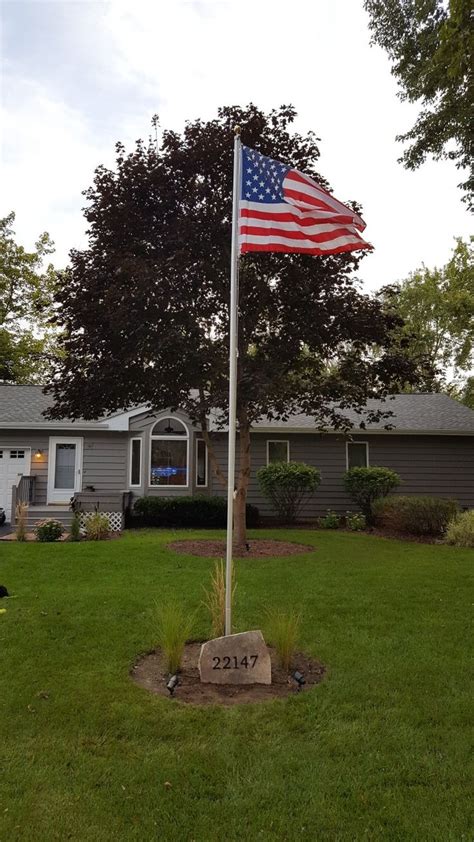 See more ideas about flag pole, flag pole landscaping, front yard. American flag pole with flag stone address and tall grass ...