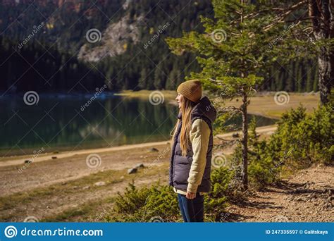 Woman Tourist In Background Of Panoramic Morning View Of Black Lake