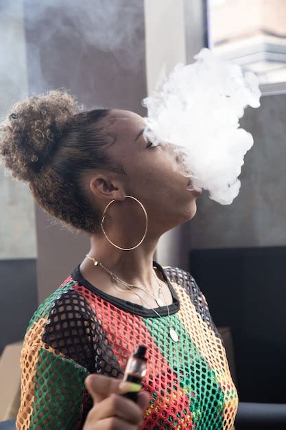 Premium Photo Vertical Photo Of A Black Girl With Big Rings Smoking
