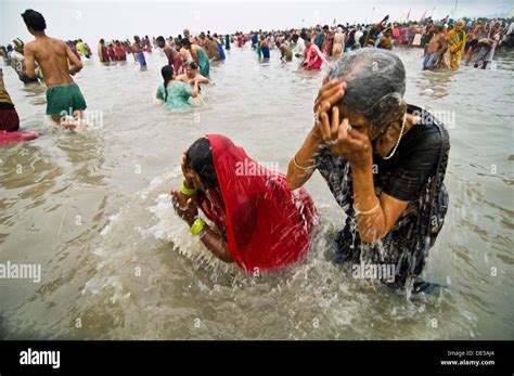 Pilgrims Dip In The Holy Ganges Water At Gangasagar Island In West