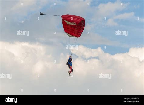 Red Parachute Jumpers In The Sky Stock Photo Alamy