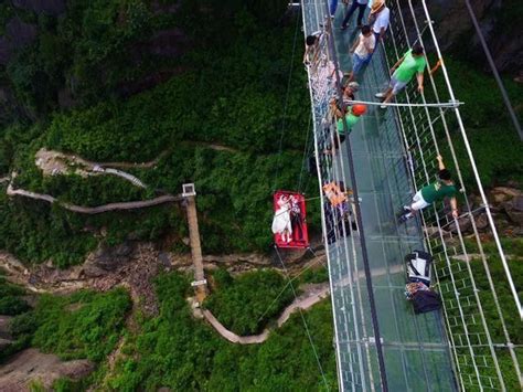 Chinese Couple Dangle From Suspension Bridge For Wedding Couples
