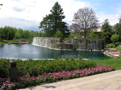 They can be as little as a a costly and large undertaking, but effective process, is dredging. Large cascading waterfall with patio overlooking man-made ...