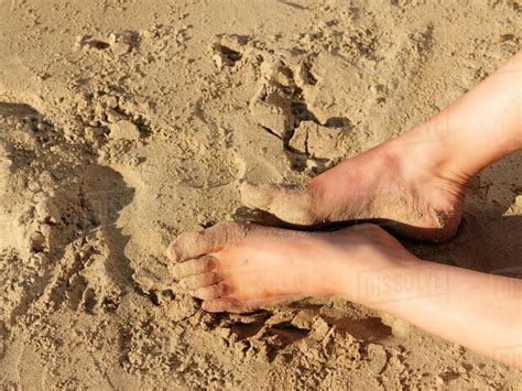 Legs Resting On Sand Stock Photo Dissolve