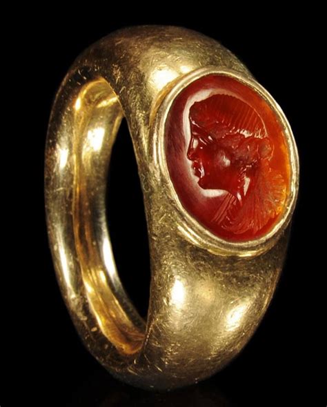 An Ancient Roman Gold Ring Set With A Carnelian Intaglio Of A Woman