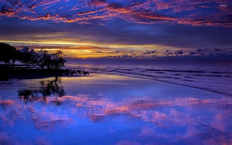 Amazing Purple Sunset Clouds Reflected In The Wet Beach Wallpaper
