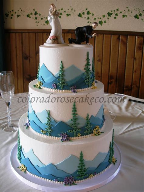 A Tiered Cake Decorated With Mountain Scenery I Love The