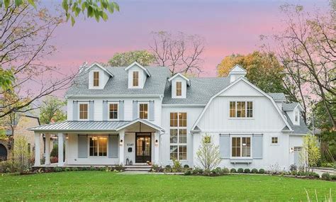 White And Gray Home Exterior Includes Light Gray Shutters On Rails A