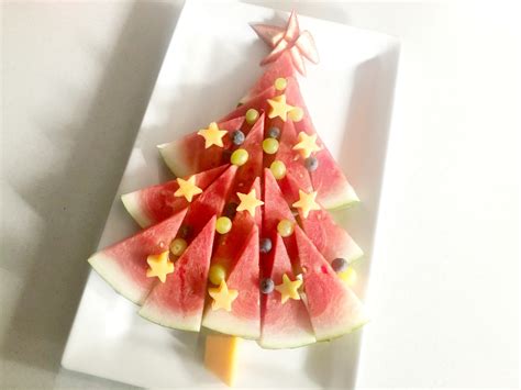 Festive holiday appetizers can be created using fresh fruits in fun and colorful ways. Make an Easy Christmas Tree Fruit Platter - The Plumbette