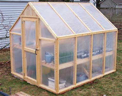 Build a wooden frame to hold the windows. Build a Greenhouse for Less Than $150 - Sustainable Simplicity