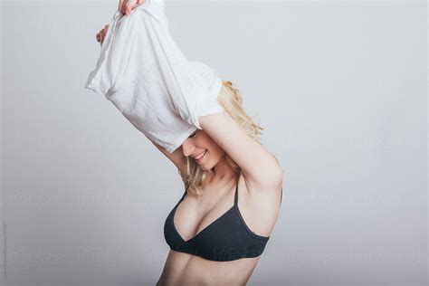 Woman Taking Shirt Off By Stocksy Contributor Studio Firma Stocksy