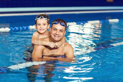 Father And Son Swim In A Swimming Pool Stock Image Colourbox