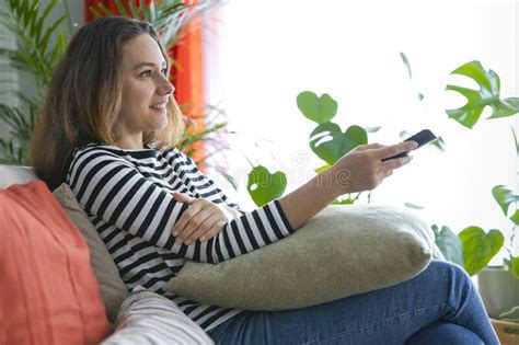 Young Woman Relaxing At Home Watching Tv Stock Photo Image Of Holding