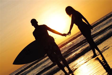 Surfing Couple At Sunset Beach Free Image Download