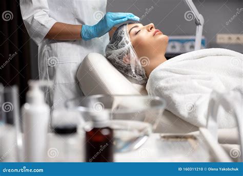 Cosmetologist In Sterile Gloves Cleaning Lady Face With Soft Pad Stock