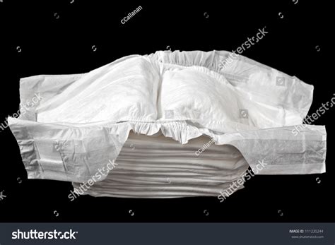 A Stack Of White Disposable Diapers Isolated On A Black