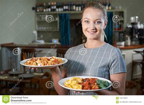 Waitress Serving Plates Of Food In Restaurant Stock Photo - Image of caucasian, plates: 104778550